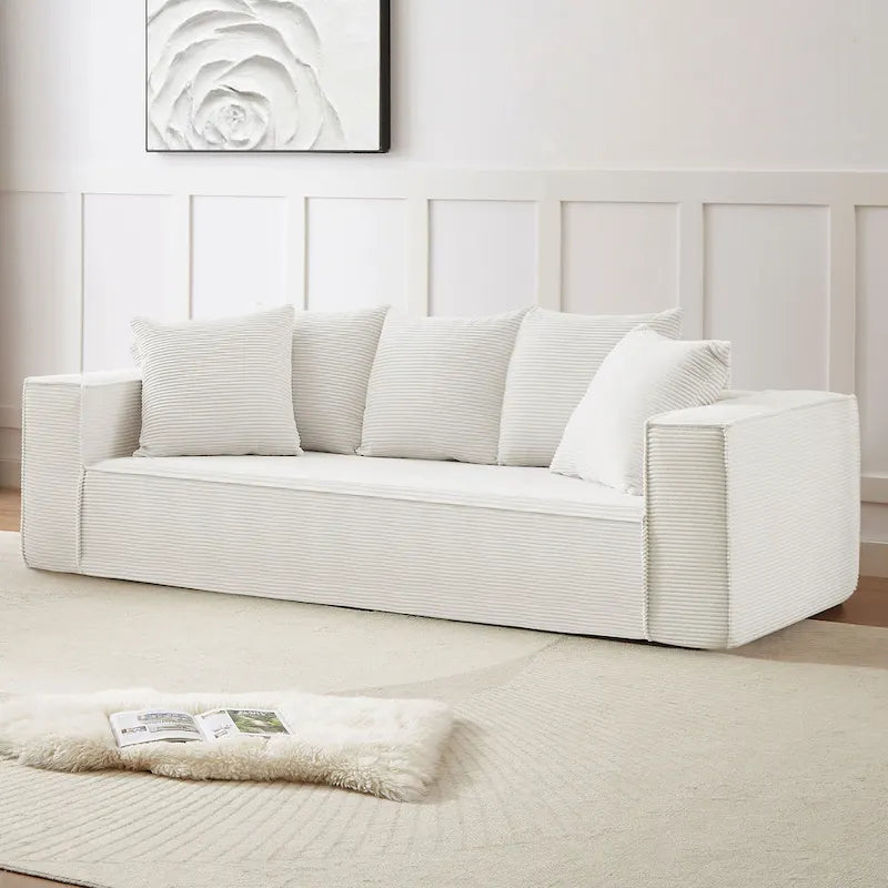 Ce canapé modulaire trois places en velours côtelé est livré avec 5 coussins et présente un design spacieux.
